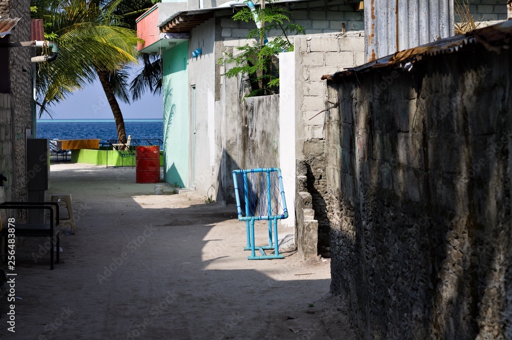 A blue seat on a typical maldivian street (Ari Atoll, Maldives)
