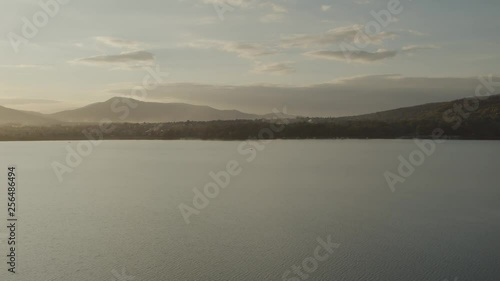 Wallpaper Mural Aerial drone shot of lonely boat on huge lake at sunset with mountains in background PRORESHQ Torontodigital.ca