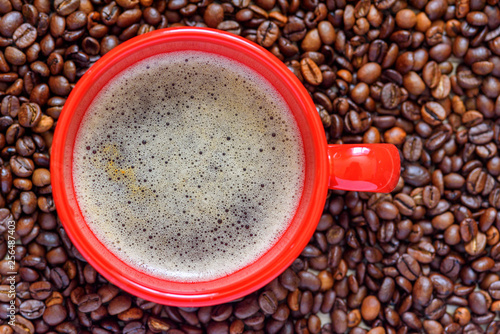 a cup of coffee on a background of coffee beans