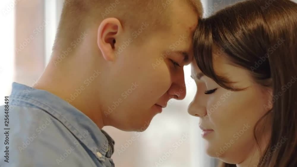 Couple smiling face to face in slow motion Happy together, passion. Man and woman touch noses of each other close up. spend romantic morning together looking at each other with great love. Couple smiling face to face in slow motion Happy together, passion. Man and woman touch noses of each other close up. spend romantic morning together looking at each other with great love.