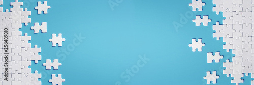 White details of puzzle on blue background photo