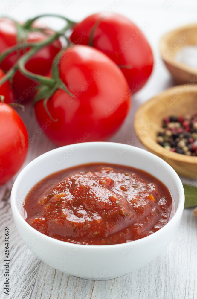 Tomato sauce in a white bowl on a table