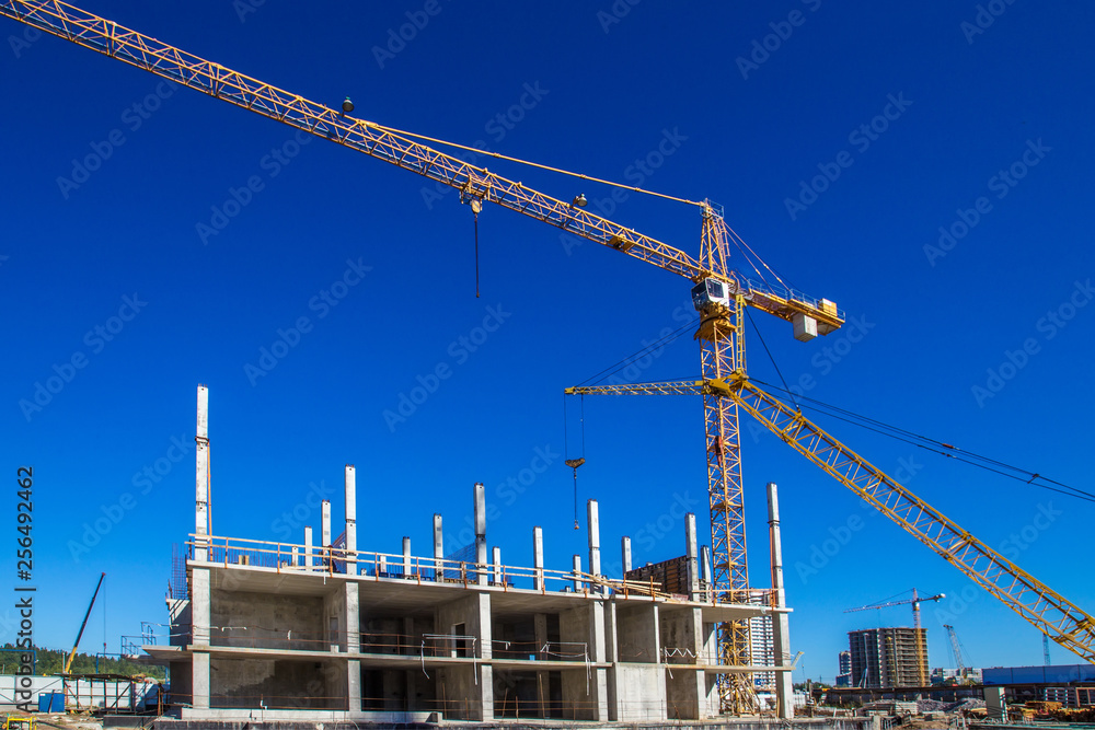 Panorama of the construction site. Construction crane. Construction of the building. Pouring cement. Walling. Panorama of the construction site. Construction crane. Construction of the building. Pouring cement. Walling.