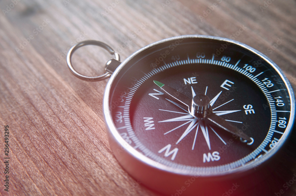 Old compass on a dark wooden background. Copy space for text or design Old compass on a dark wooden background. Copy space for text or design