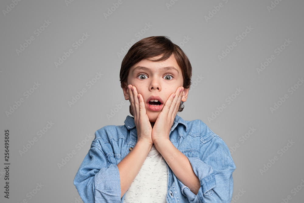 Stylish boy looking at camera in astonishment Stylish boy looking at camera in astonishment