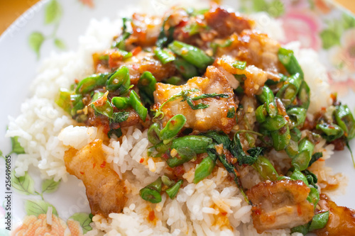 Crispy pork belly with Thai basil on rice