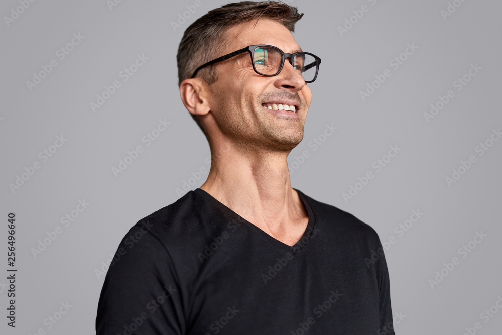 Cheerful man in glasses looking away Cheerful man in glasses looking away