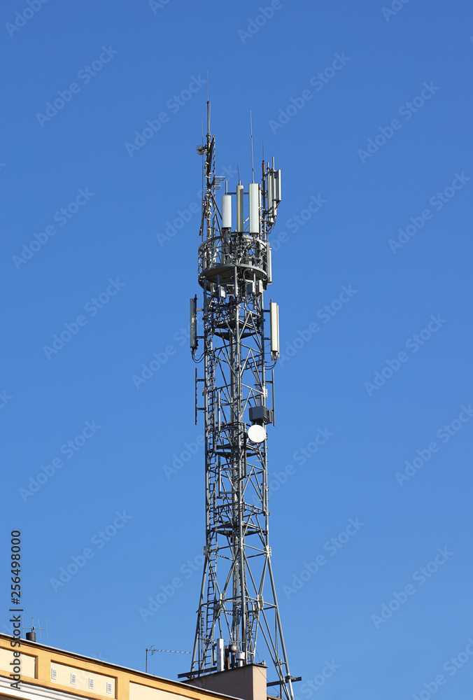 Radio tower with antennas on a blue sky background. Metal construction. Wireless network. Transmit tv radio signal. Egology of the environment. Information digitalization and high technology
