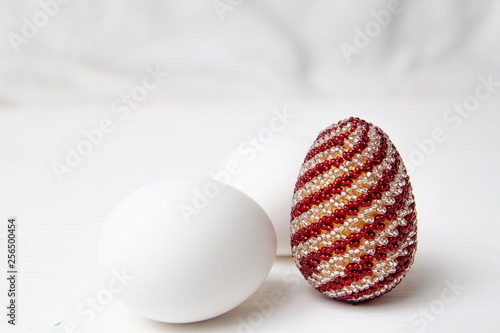 two white egg and color . White background. Preparation for Religious Easter, Resurrection of Jesus Christ