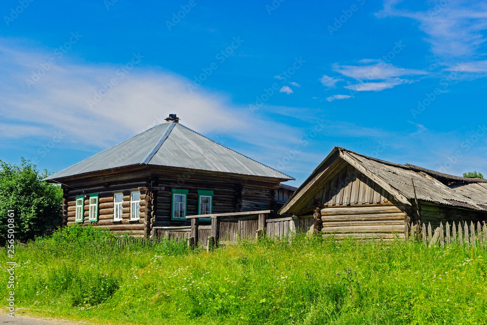 old wooden house in the village on a summer day old wooden house in the village on a summer day