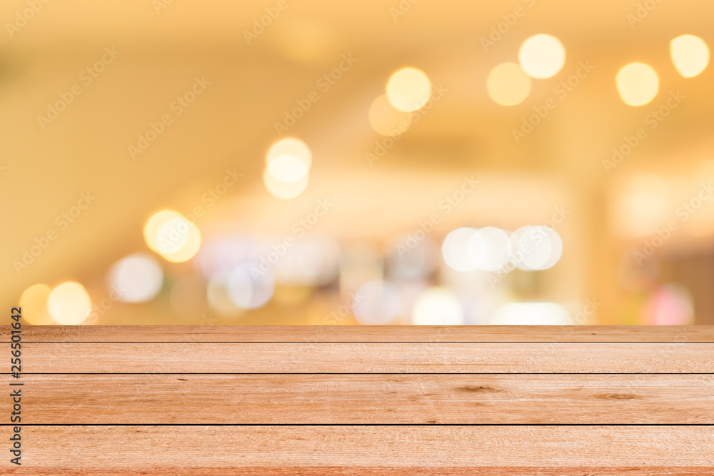 Blurred lamp light at shopping mall in white color background with old vintage grungy brown wood panel tabletop for show,promote and advertise product on display
