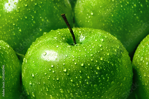 green apple with water drops close-up macro, background