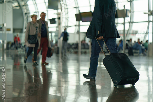 Brussels airport inside defocused image, somebody with suitcase going anywhere