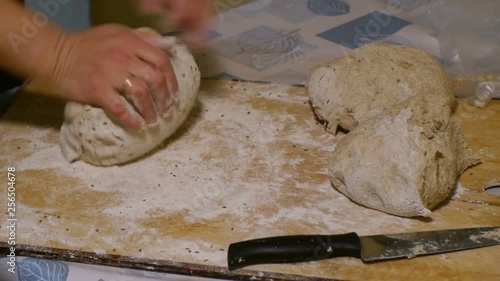Women hands knead rye dough with cumin close up