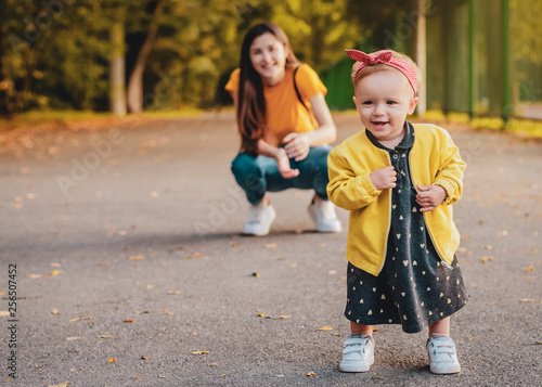 Happy family on autumn walk! Mother and daughter walking in the Park and enjoying the beautiful autumn nature. Family holiday and togetherness, selective focus, noise effect