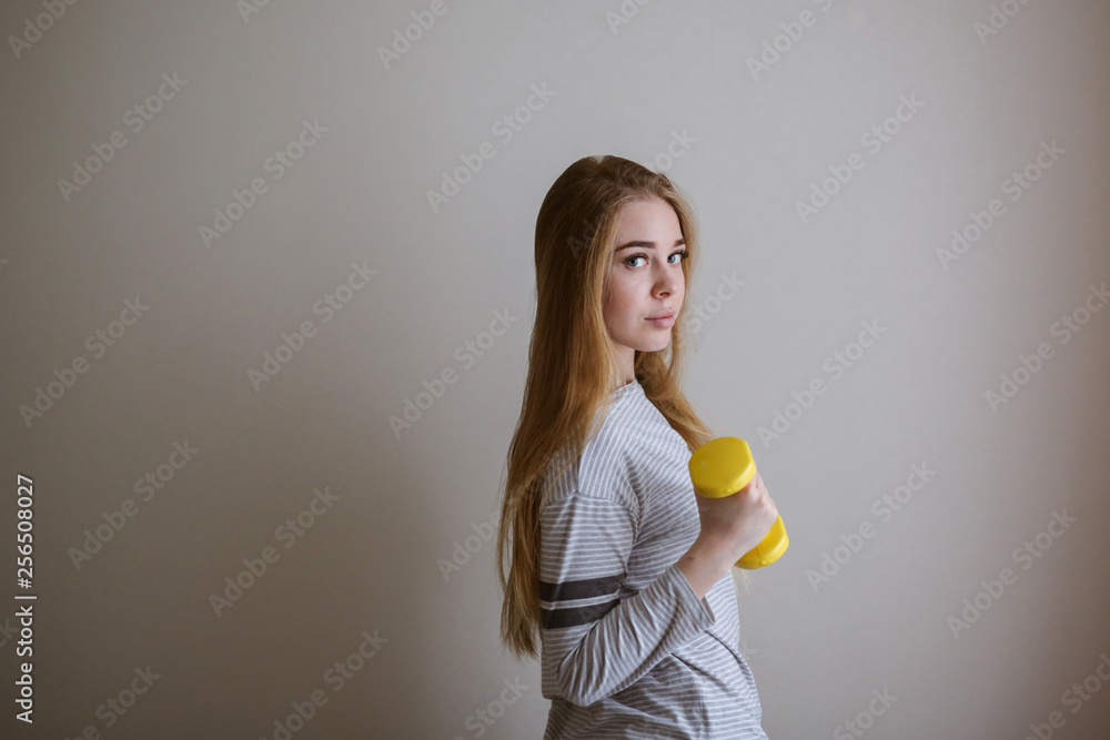 student doing exercises with dumbbells,home sports student doing exercises with dumbbells,home sports