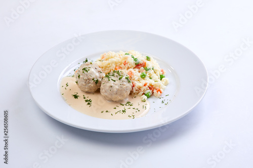 meatballs with rice and vegetables on the white background