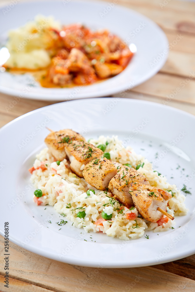 chicken kebab with rice and vegetables on the wooden background chicken kebab with rice and vegetables on the wooden background