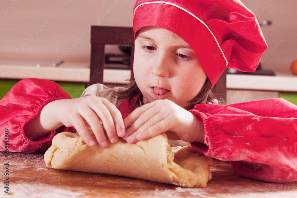Dough home cuisine. Portrait of little beautiful child girl chef. Dough home cuisine. Portrait of little beautiful child girl chef.