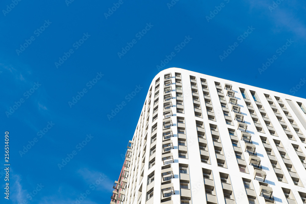 Modern new multi-storey residential building against the blue sky. business card concept Modern new multi-storey residential building against the blue sky. business card concept