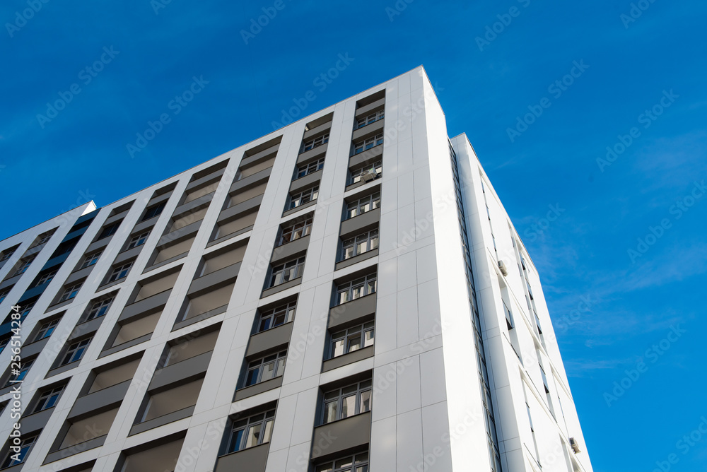 Modern new multi-storey residential building against the blue sky. business card concept Modern new multi-storey residential building against the blue sky. business card concept