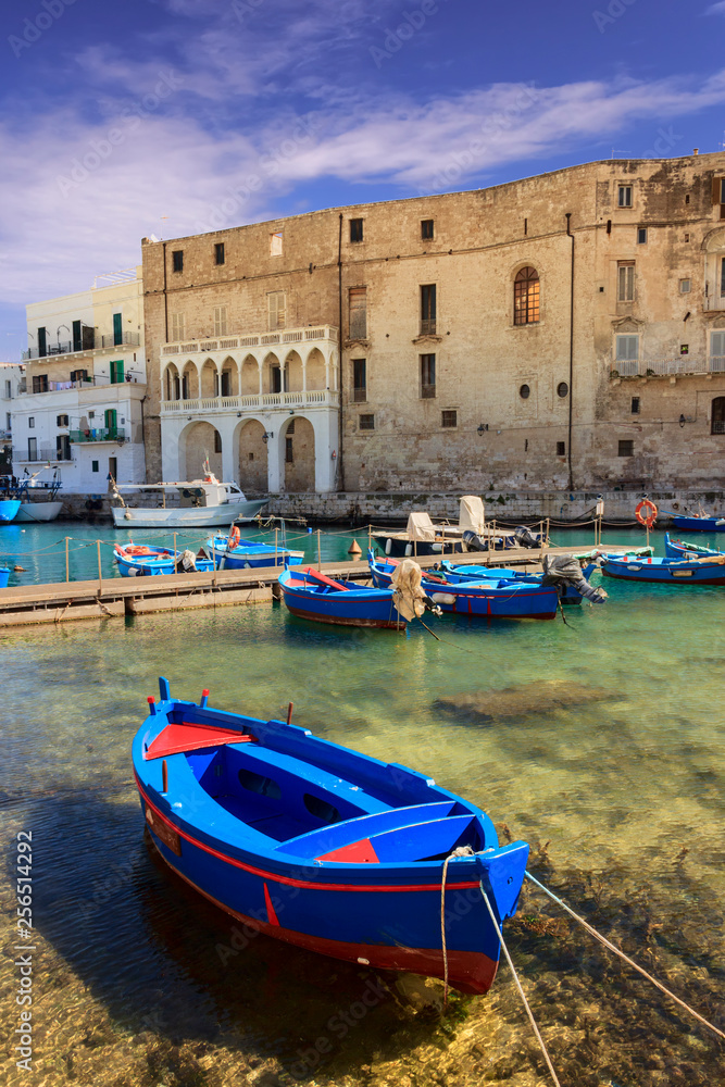 Old port of Monopoli province of Bari, region of Apulia, southern Italy. view of the old town with fishing and rowing boats, Italy.
