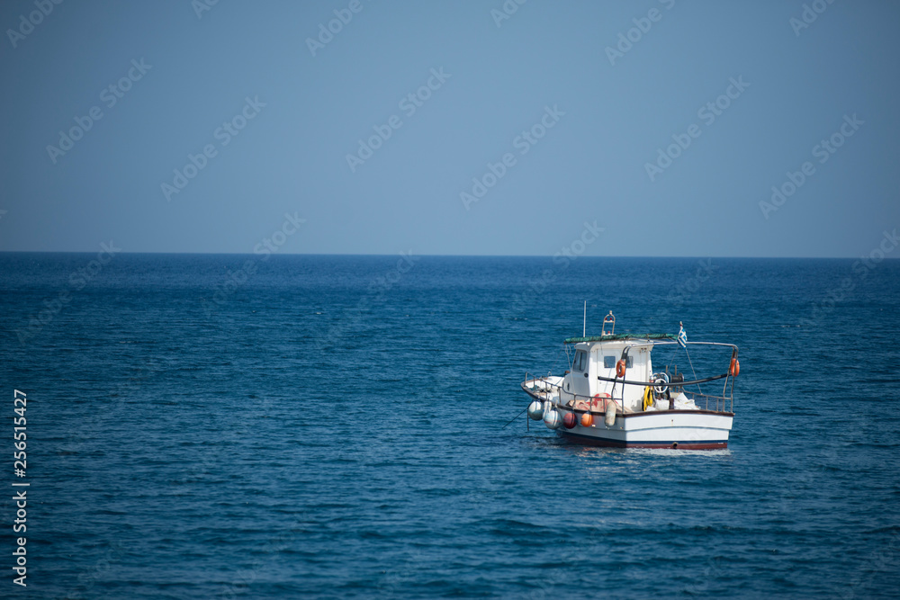 Santorini, August 05, 2015: A Boat alone in the sea Santorini, August 05, 2015: A Boat alone in the sea