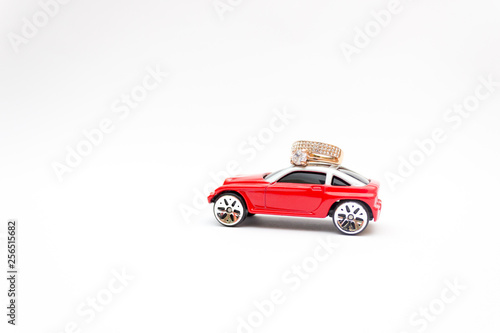 Red toy car  golden ring  marriage proposal  happiness concept
