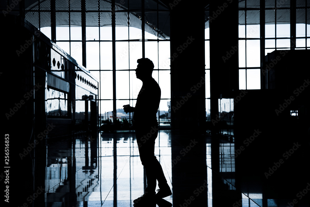 An anonymous men looking for information screen in an airport An anonymous men looking for information screen in an airport