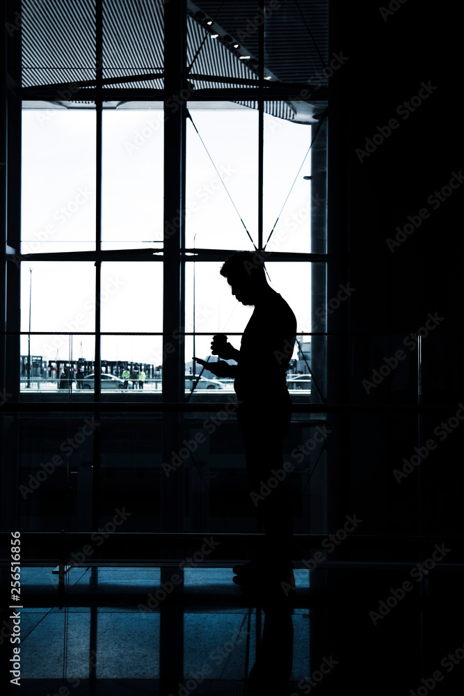 An anonymous men looking to his mobile phone An anonymous men looking to his mobile phone