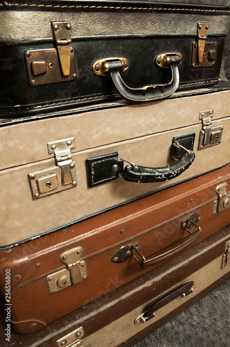 old and damaged suitcases stacked on top of each other