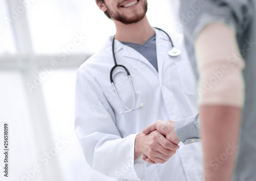 patient shakes hands with his physician