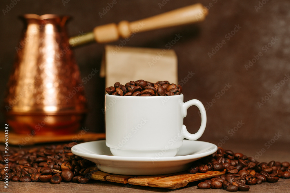 Fototapeta premium Turkish coffee brewing pot. Cup with coffee beans