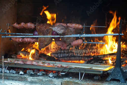 live-fire cooking / grilled meat in an old barbecue, cooking over solid-fuels