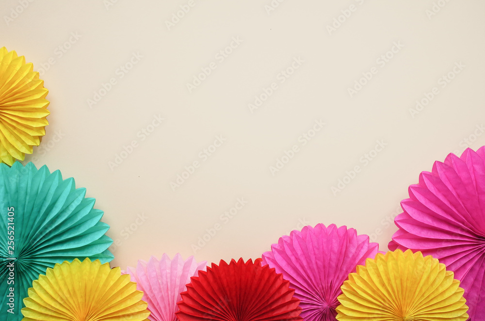 Paper texture color flowers on light background. Birthday, holiday or party background. Flat lay style.