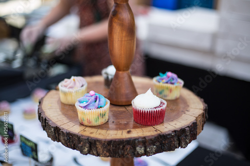 Bright colored cupcakes on display outdoors