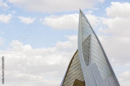 modern urban exterior object sails shape from irons materials on blue sky with clouds background concept photography with empty copy space