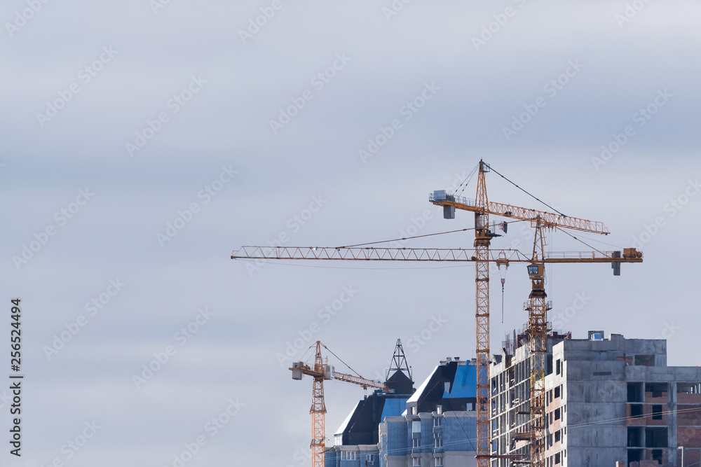 construction crane builds a house against the sky construction crane builds a house against the sky