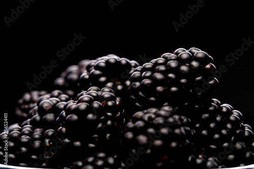 Close up photo of blackberry on empty black background.