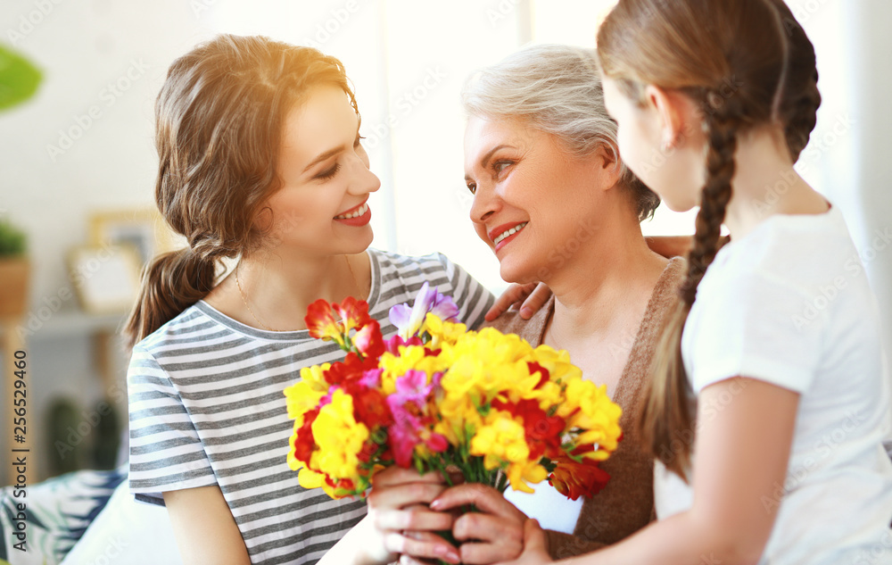 mother's day! three generations of family mother, grandmother and daughter congratulate on the holiday, give flowers . mother's day! three generations of family mother, grandmother and daughter congratulate on the holiday, give flowers .