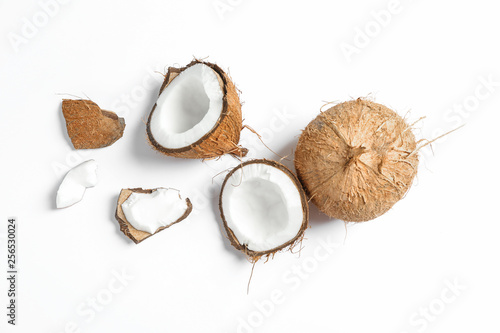 Two coconut one of which split on white background