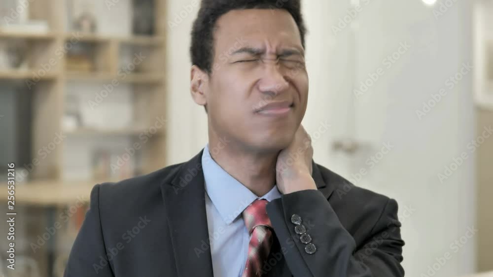 African Businessman with Neck Pain African Businessman with Neck Pain