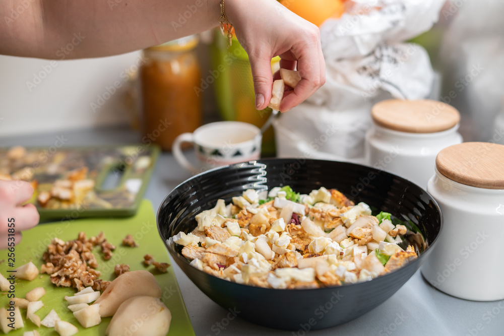 Woman prepares a salad with chicken. Woman prepares a salad with chicken.