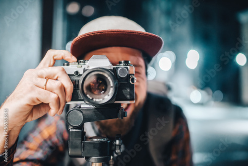 Man taking photo on vintage film camera photo