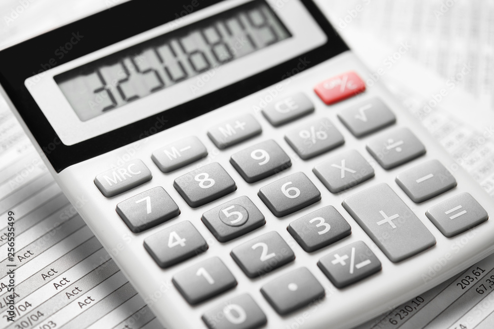 Calculator and reports closeup. Office supplies for working and calculating finance. Business financial accounting concept. Calculator and reports closeup. Office supplies for working and calculating finance. Business financial accounting concept.