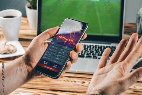 Obraz na plátne Man celebrating victory after making bets at bookmaker website