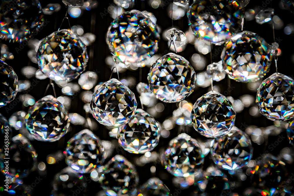 Abstract crystal chandelier pendant or crystal faceted balls background on black Abstract crystal chandelier pendant or crystal faceted balls background on black