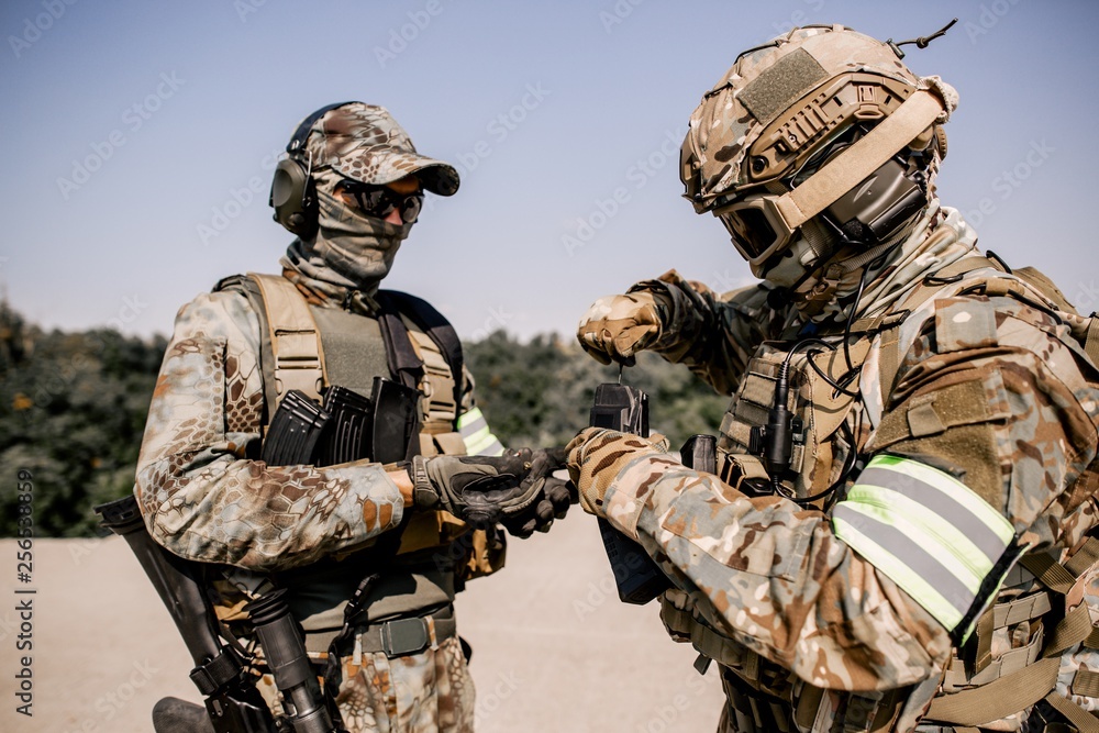 Fototapeta premium Soldiers reload rifles preparing to fire