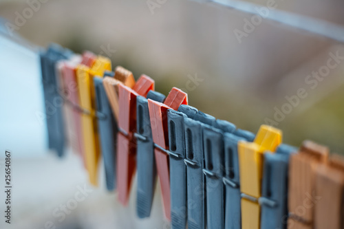Colorful clothespins outdoor, on the rope over blur background.