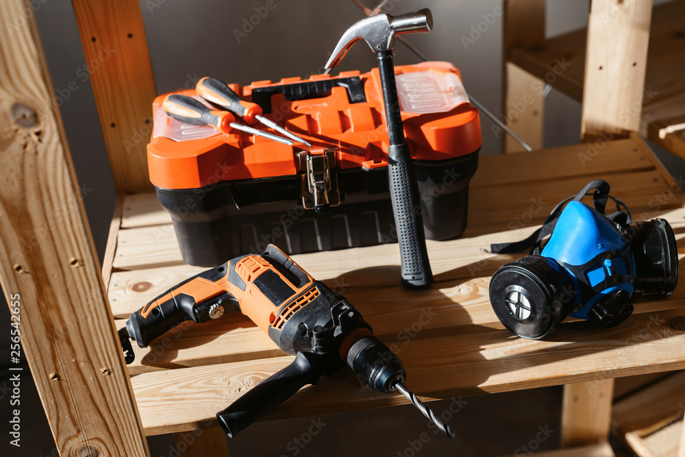 Set of various different tools in sunlight. Plastic tools kit, hammer, drill, gloves. Construction and home renovation concept with copy space